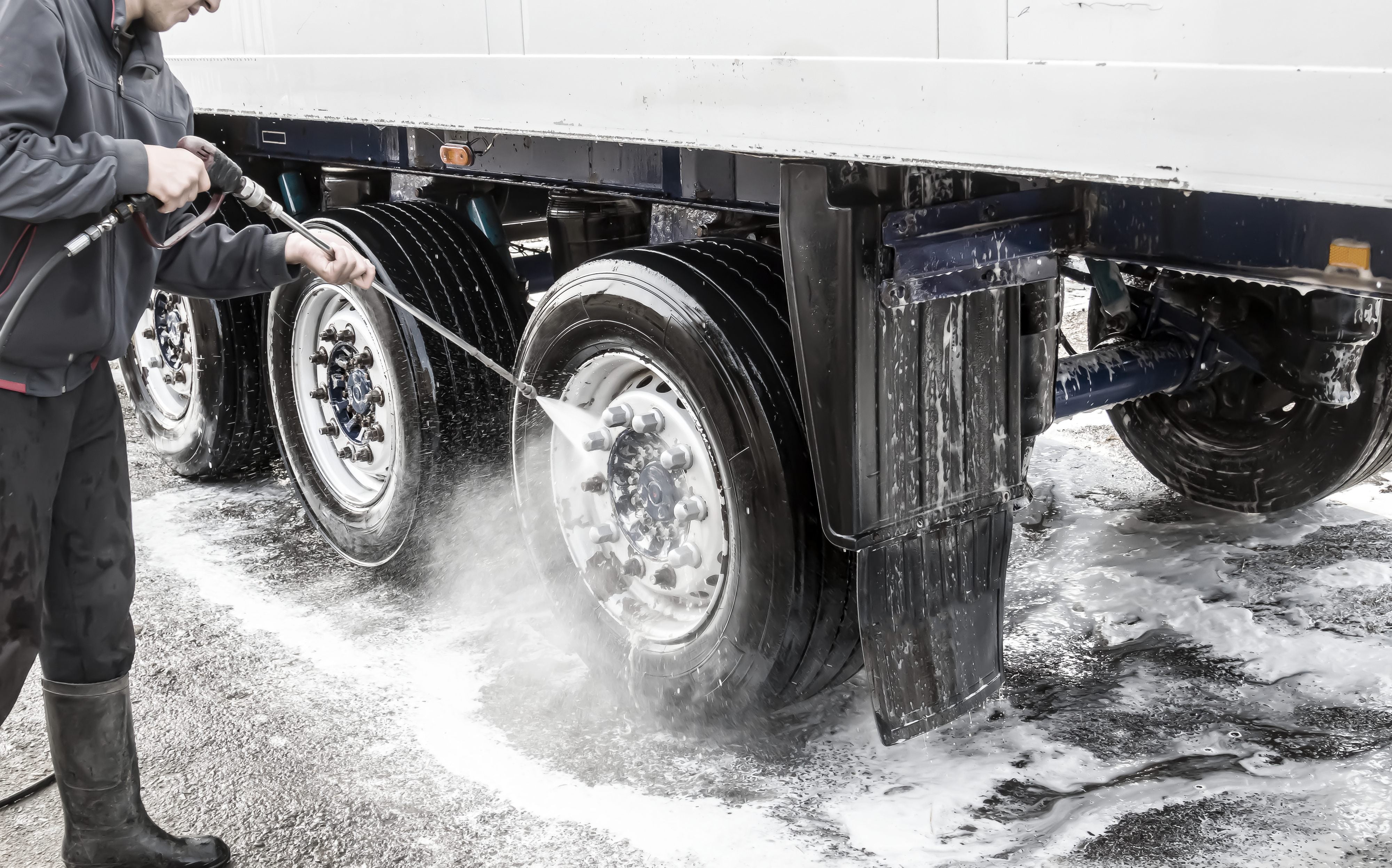 Fleet vehicle's tires being washed with fleet wash chemicals